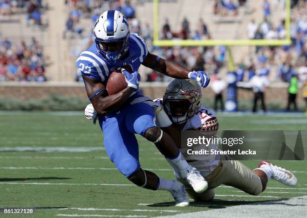 Adonis Thomas of the Florida State Seminoles tackles Brittain Brown of the Duke Blue Devils during their game at Wallace Wade Stadium on October 14,...