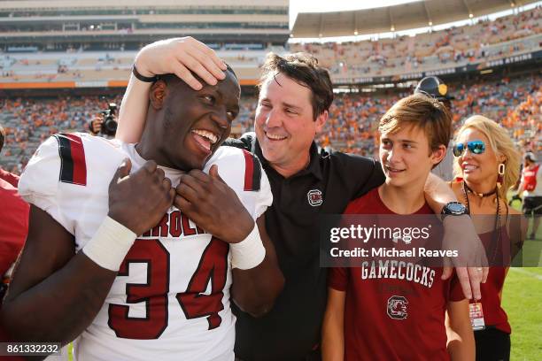 Head coach Will Muschamp of the South Carolina Gamecocks celebrates with his son, Whit Muschamp, and Mon Denson after the game against the Tennessee...