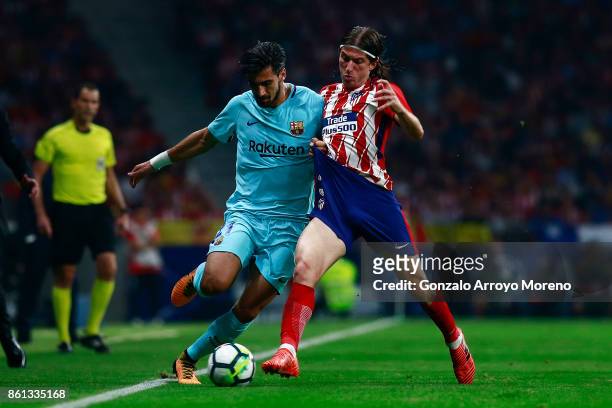 Andre Gomes of FC Barcelona competes for the ball with Filipe Luis of Atletico de Madrid during the La Liga match between Club Atletico Madrid and FC...