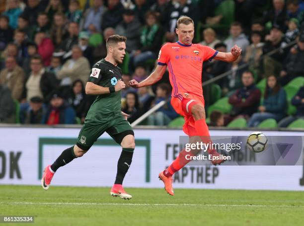 Mihailo Ristic of FC Krasnodar is challenged by Vasili Berezutski of FC CSKA Moscow during the Russian Premier League match between FC Krasnodar v FC...