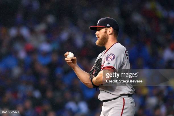 Stephen Strasburg of the Washington Nationals prepares to throw a pitch against the Chicago Cubs during game four of the National League Division...