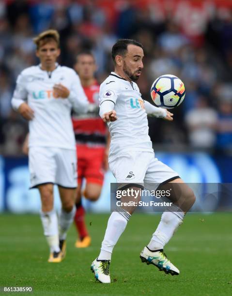 Swansea player Leon Britton in action during the Premier League match between Swansea City and Huddersfield Town at Liberty Stadium on October 14,...