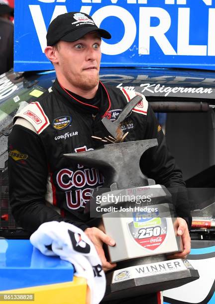 Parker Kligerman, driver of the Food Country USA/Lopez Wealth Mgmt Toyota, poses for a photo in Victory Lane after winning the NASCAR Camping World...