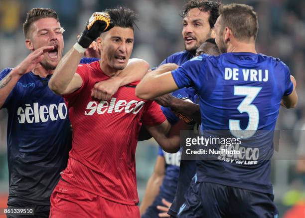 Lazio's goalkeeper Stefan Strakosha of Albania is congratulated by teammates after saving a penalty during the Italian Serie A football match...