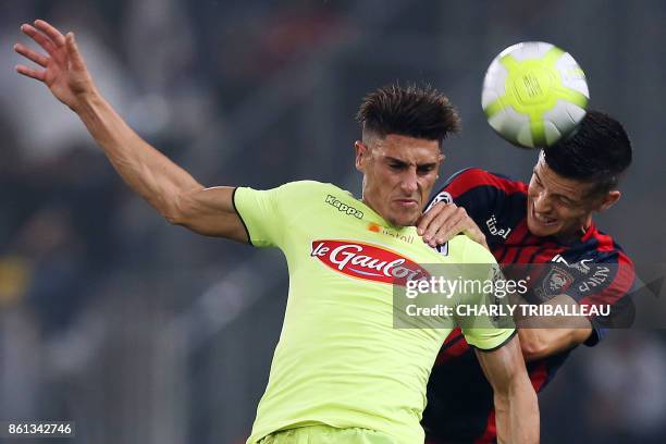 Angers's Algerian defender Mehdi Tahrat vies for the ball with Caen's Belgian midfielder Stef Peeters during the French L1 football match between...