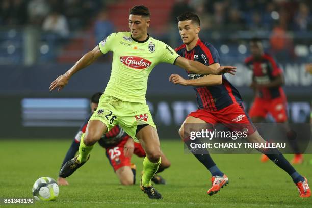 Angers's Algerian defender Mehdi Tahrat vies for the ball with Caen's Belgian midfielder Stef Peeters during the French L1 football match between...