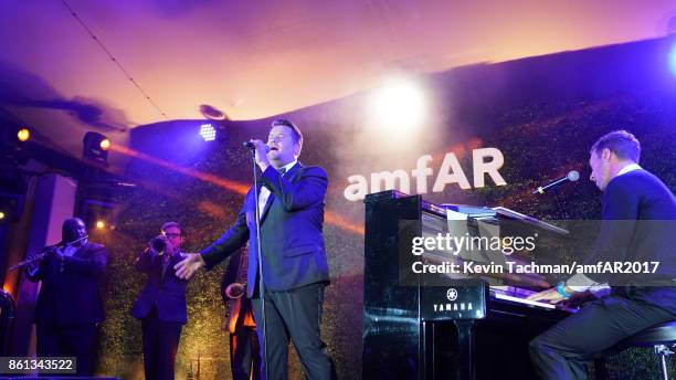 James Corden and Chris Martin perform onstage at amfAR Los Angeles 2017 at Ron Burkle's Green Acres Estate on October 13, 2017 in Beverly Hills,...