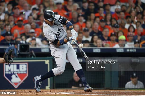 Starlin Castro of the New York Yankees breaks hit bat on a single in the second inning against the Houston Astros during game two of the American...