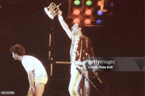 Photo of Freddie MERCURY and John DEACON and QUEEN, John Deacon and Freddie Mercury performing live on stage