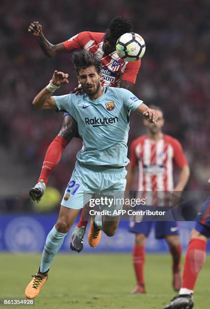 Atletico Madrid's Ghanaian midfielder Thomas vies with Barcelona's Portuguese midfielder Andre Gomes during the Spanish league football match Club...