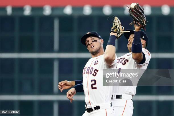 Carlos Correa and Alex Bregman of the Houston Astros collide catching a pop fly by Greg Bird of the New York Yankees in the second inning during game...