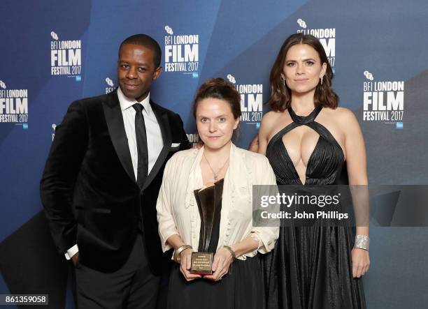 Lucy Cohen poses in the winners room with her Best Documentary award won for 'Kingdom Of Us' and Adrian Lester and Hayley Atwell at the 61st BFI...