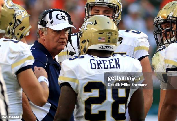 Head coach Paul Johnson of the Georgia Tech Yellow Jackets talks to J.J. Green during a game against the Miami Hurricanes at Sun Life Stadium on...