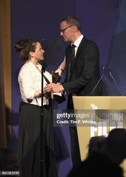 Grierson Jury member John Battsek presents Lucy Cohen with the award for Best Documentary Competition Winner for 'Kingdom of Us' on stage during the...