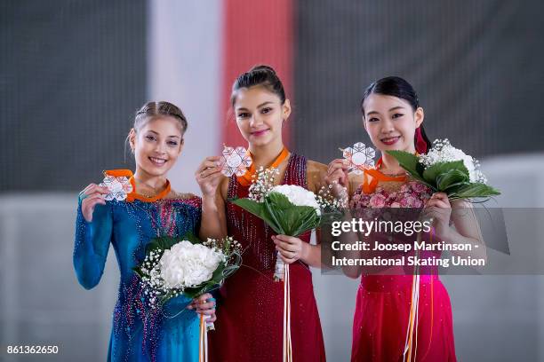 Alena Kostornaia of Russia, Sofia Samodurova of Russia and Rika Kihira of Japan pose in the Junior Ladies medal ceremony during day three of the ISU...