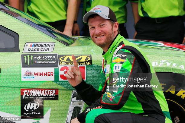 Dale Earnhardt Jr., driver of the Mountain Dew Chevrolet, poses with the Coors Light Pole Award after qualifying in the pole position for the Monster...