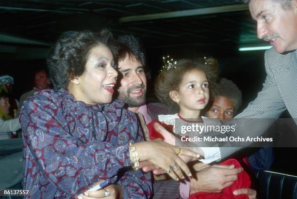 Singer Minnie Riperton, her husband Richard Rudolph, and children Maya Rudolph and Marc Rudolph greet a fan at the Hollywood Christmas Parade in...