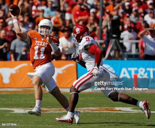 Texas quarterback Sam Ehlinger throws under pressure from Oklahoma linebacker Kenneth Murray in the first quarter during the annual Red River...