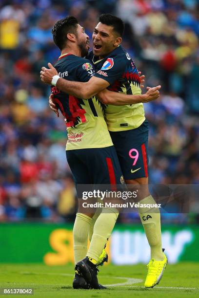 Oribe Peralta and Silvio Romero of America celebrate the second goal of their team during the 13th round match between Cruz Azul and America as part...