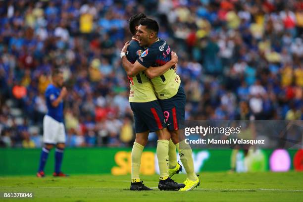 Oribe Peralta and Silvio Romero of America celebrate the second goal of their team during the 13th round match between Cruz Azul and America as part...