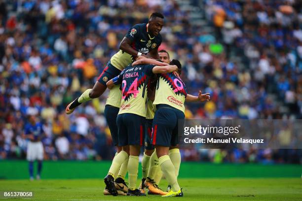 Oribe Peralta of America celebrates with his teammates after scoring the second goal of his team during the 13th round match between Cruz Azul and...