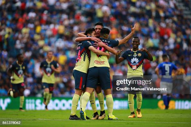 Oribe Peralta of America celebrates with his teammates after scoring the second goal of his team during the 13th round match between Cruz Azul and...