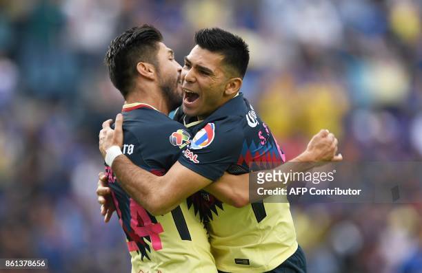 America's Oribe Peralta celebrates with Argentine teammate Silvio Romero after scoring against Cruz Azul during their Mexican Apertura football...