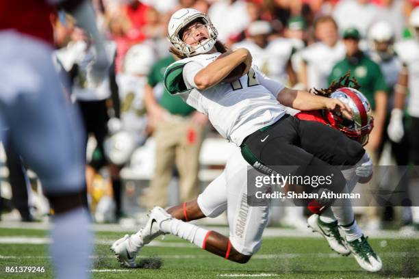 Quarterback Brooks Barden of the Charlotte 49ers is tacked by Defensive Back Drell Greene of the Western Kentucky Hilltoppers at L.T. Smith Stadium...