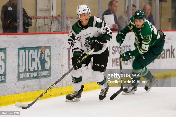 Sam Malinski of the Cedar Rapids RoughRiders skates with the puck against Samuel Salonen of the Sioux City Musketeers during the game on Day 1 of the...