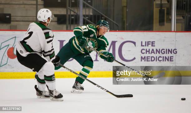 Carl Ehrnberg of the Sioux City Musketeers handles the puck against Graham Slaggert of the Cedar Rapids RoughRiders during the game on Day 1 of the...
