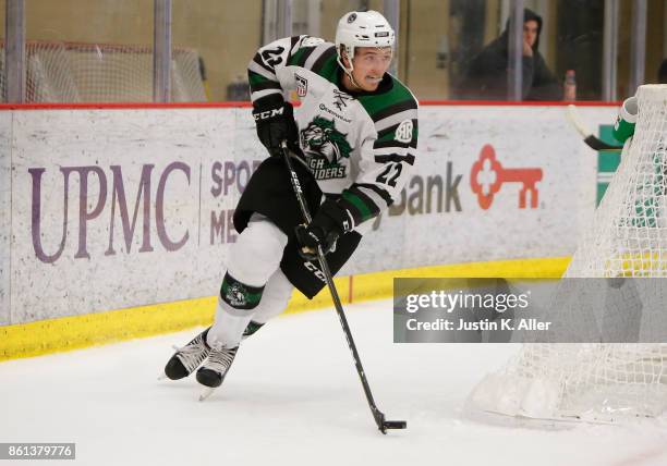 Graham Slaggert of the Cedar Rapids RoughRiders skates with the puck during the game against the Sioux City Musketeers on Day 1 of the USHL Fall...