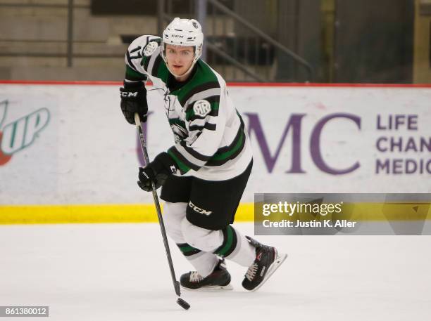 Neil Shea of the Cedar Rapids RoughRiders skates with the puck during the game against the Sioux City Musketeers on Day 1 of the USHL Fall Classic at...