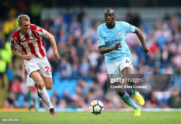 Yaya Toure of Manchester City beats Darren Fletcher of Stoke City during the Premier League match between Manchester City and Stoke City at Etihad...
