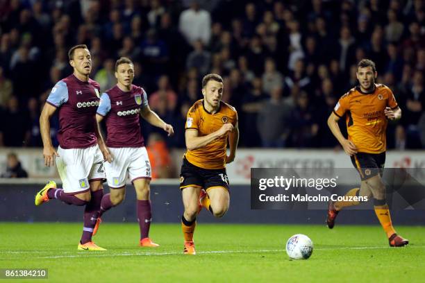 Diogo Jota of Wolverhampton Wanderers gets past John Terry and James Chester of Aston Villa John Terry of Aston Villa during the Sky Bet Championship...