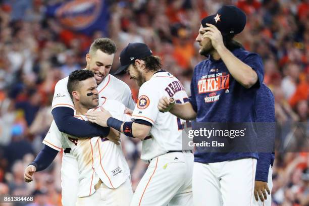 Jose Altuve of the Houston Astros celebrates with teammates after scoring the winning run in their 2-1 win over the New York Yankees during game two...