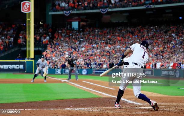 Carlos Correa of the Houston Astros hits a double in the ninth inning scoring Jose Altuve to win game two of the American League Championship Series...