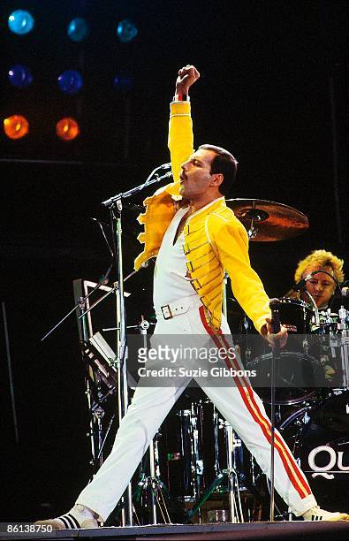 Freddie Mercury of Queen performs on stage with drummer Roger Taylor behind on the Magic Tour at Wembley Stadium, London, July 1986.