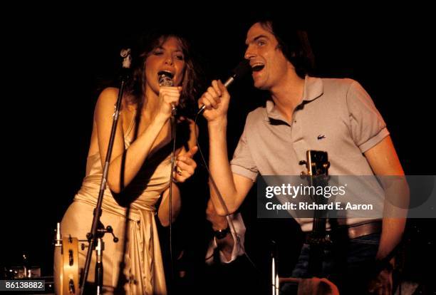 Photo of Carly SIMON and James TAYLOR; performing on stage with Carly Simon