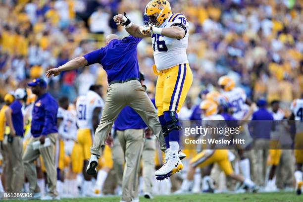 Austin Deculus and a assistant coach of the LSU Tigers celebrate af the end of the game against the Auburn Tigers at Tiger Stadium on October 14,...