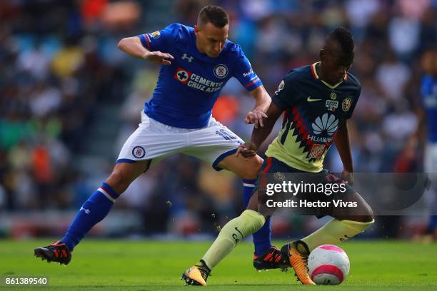 Christian Gimenez of Cruz Azul struggles for the ball with Darwin Quintero of America during the 13th round match between Cruz Azul and America as...