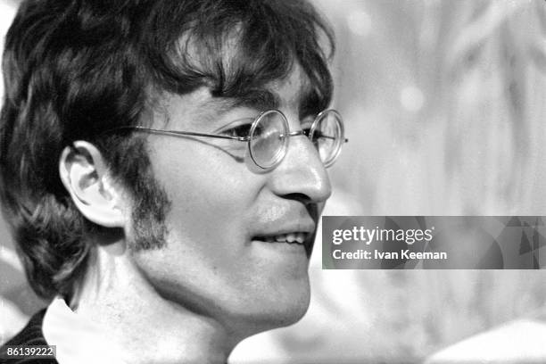 John Lennon of English rock and pop group The Beatles posed during a press call to promote the band's performance of the song 'All You Need Is Love'...