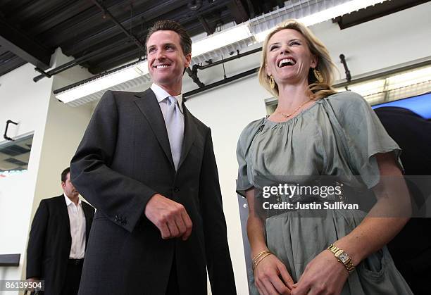 San Francisco Mayor Gavin Newsom and his wife Jennifer Siebel speak to reporters following a visit to the Facebook headquarters April 21, 2009 in...