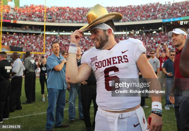Baker Mayfield of the Oklahoma Sooners wears the Golden Hat Trophy after the 29-24 win over the Texas Longhorns at Cotton Bowl on October 14, 2017 in...