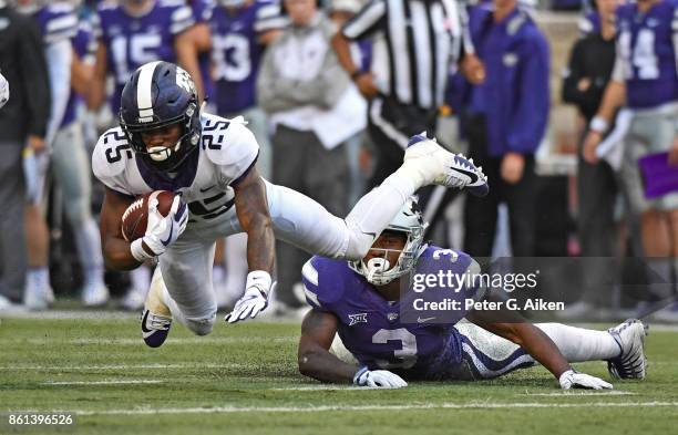 Wide receiver KaVontae Turgin of the TCU Horned Frogs gets tripped up from behind by linebacker Elijah Sullivan of Kansas State Wildcats during the...