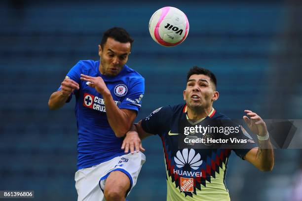 Omar Mendoza of Cruz Azul goes for a header with Silvio Romero of America during the 13th round match between Cruz Azul and America as part of the...