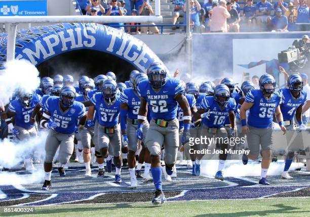 Jacoby Hill of the Memphis Tigers leads his team on the field before a game against the Navy Midshipmen on October 14, 2017 at Liberty Bowl Memorial...