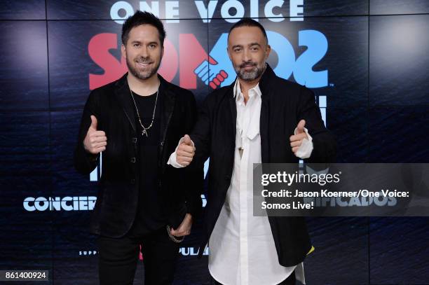 In this handout photo provided by One Voice: Somos Live!, Pablo Hurtado and Mario Domm of 'Camila' pose in the pressroom at One Voice: Somos Live! A...