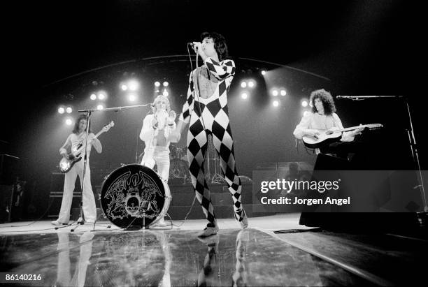 Photo of QUEEN; L-R John Deacon, Roger Taylor, Freddie Mercury and Brian May performing on stage at Broendby Hall