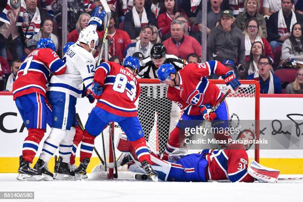 Patrick Marleau of the Toronto Maple Leafs gets the puck past goaltender Carey Price with Ales Hemsky and teammate Jeff Petry of the Montreal...