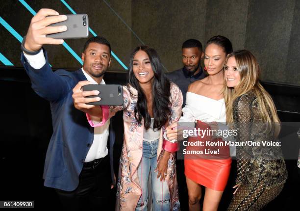 In this handout photo provided by One Voice: Somos Live!, NFL player Russell Wilson, singer Ciara, actor Jamie Foxx, model Joan Smalls and Heidi Klum...